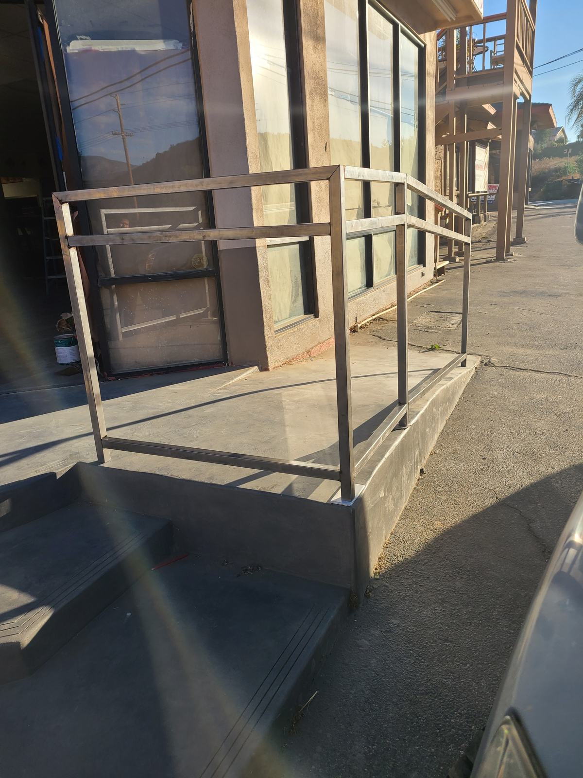 Steel handrail at a storefront ramp