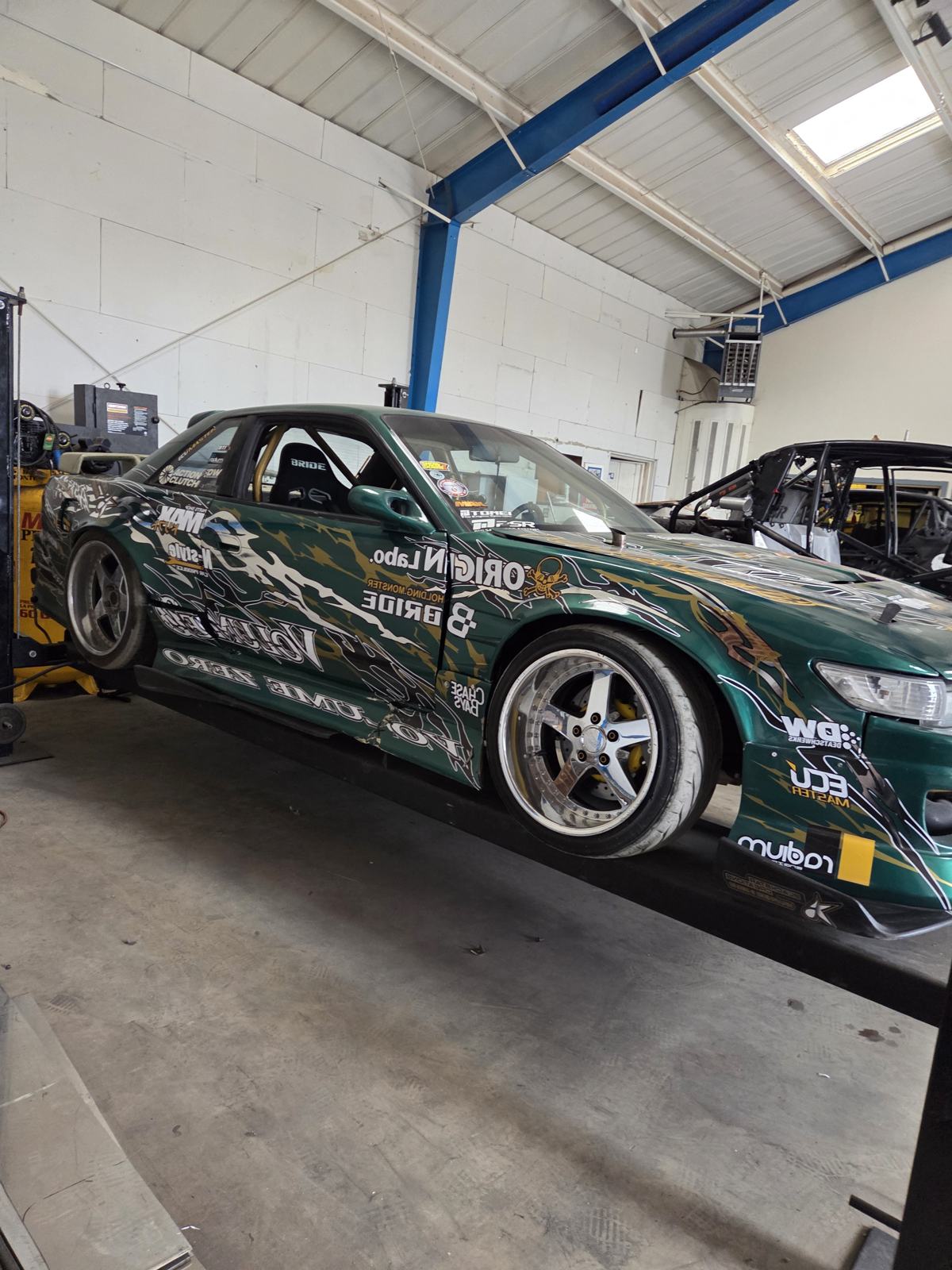 Drift car on the lift in the Draco Fab Worx shop