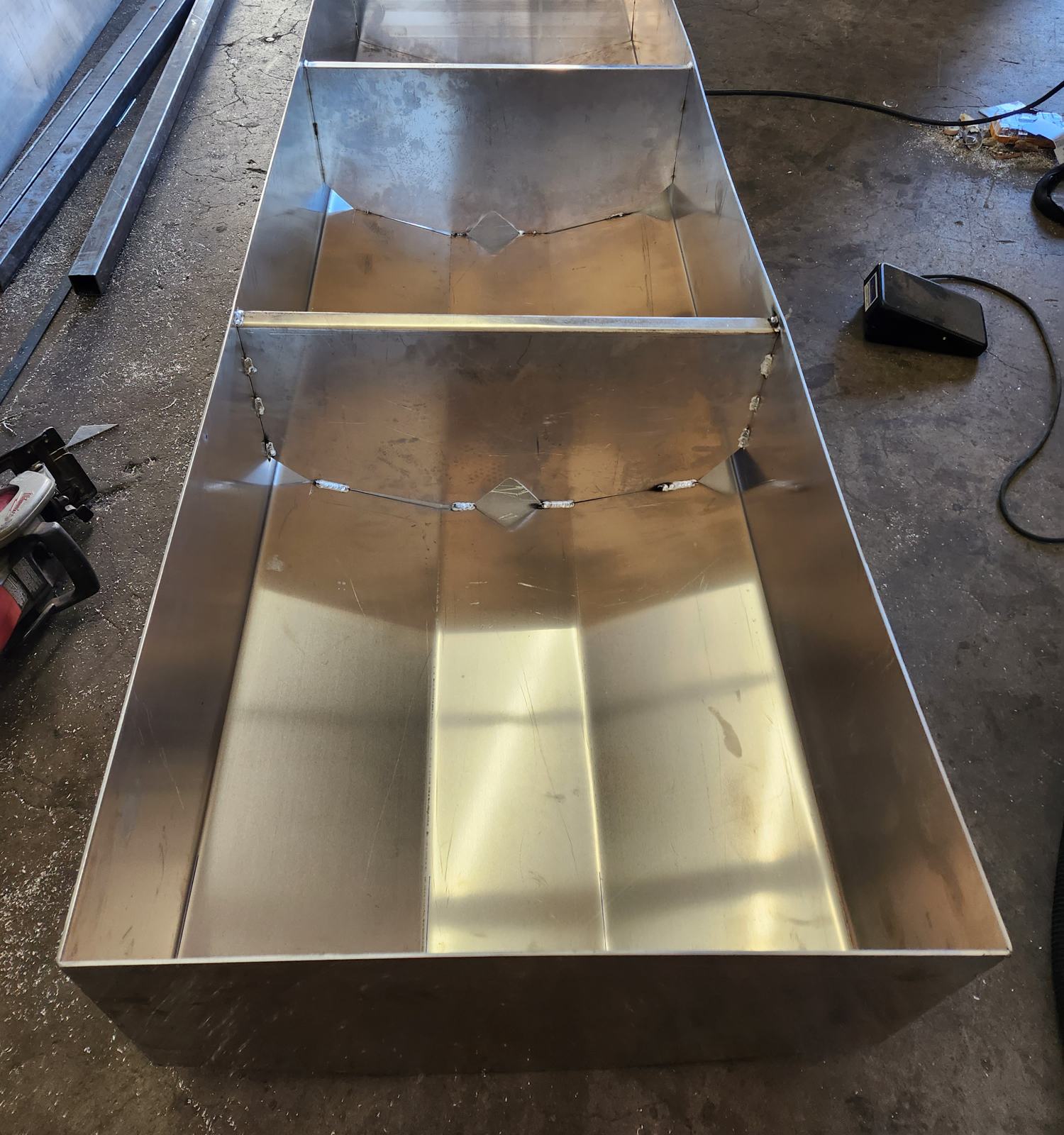 Large aluminum tank in progress showing internal baffles